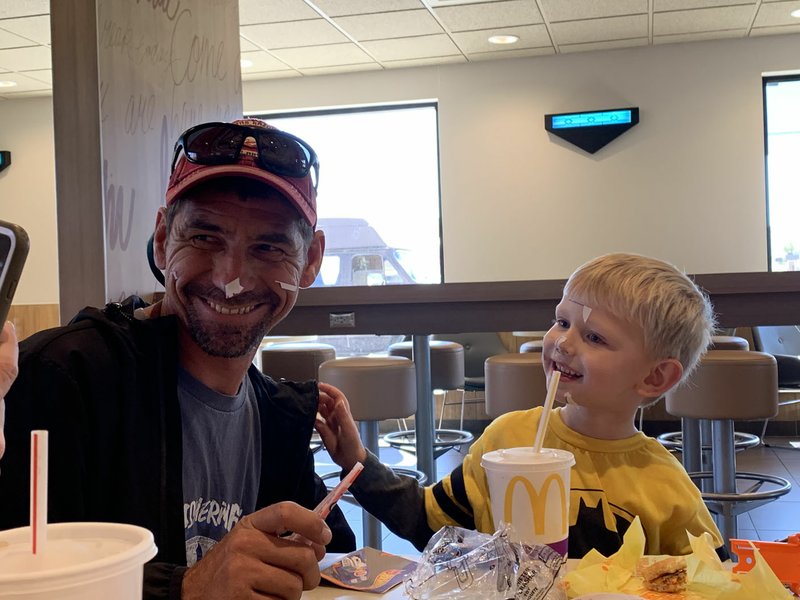 Wesly Casebolt and his mom's fiance, Eddie Harrell Jr., pose for a photo after a happy Happy Meal. You have to finish your food before you play with your toys, Wesly reminds. (Special to the NWA Democrat-Gazette/Victoria Burnett)