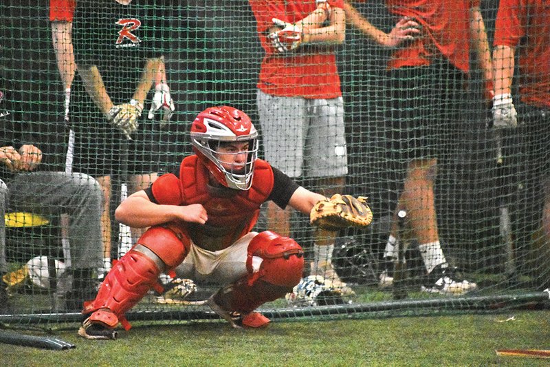 Junior Brant Stevens catches a pitch during practice Feb. 19 at the Cyclones’ indoor practice facility.