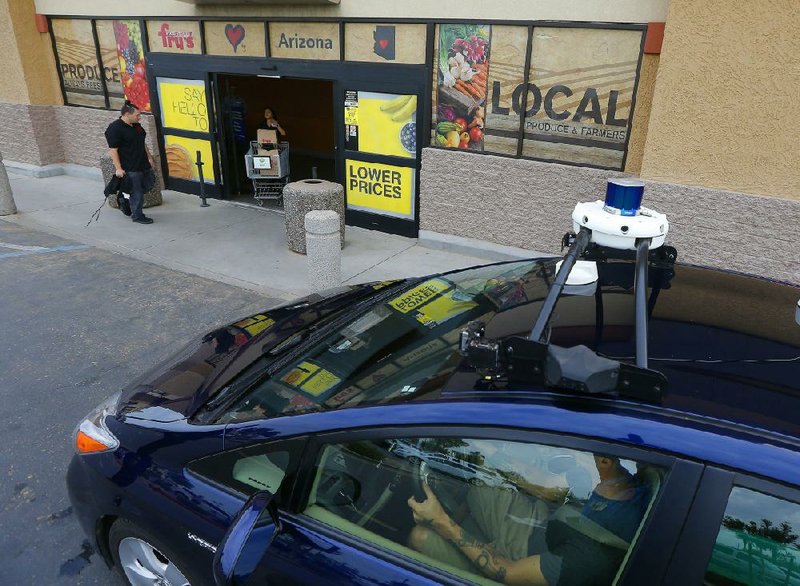 A self-driving Nuro vehicle is parked outside a Fry’s supermarket in Scottsdale, Ariz., in this 2018 photo. The U.S. government is releasing new regulations designed to update auto passenger safety standards related to autonomous vehicle operation.
(AP)