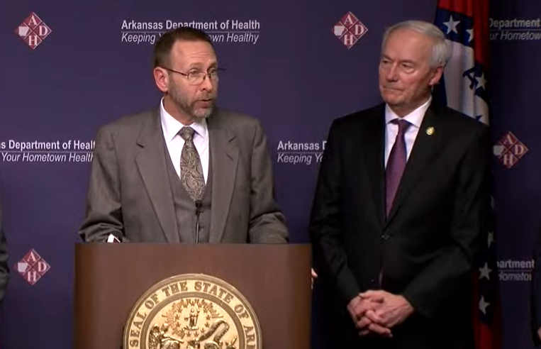 Arkansas health secretary Dr. Nate Smith talks alongside Gov. Asa Hutchinson, right, at a news conference on Thursday.