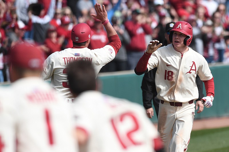 Arkansas' Heston Kjerstad gets met at home plate after hitting a home run in the bottom of the ninth inning to beat South Alabama Sunday March 8, 2020 at Baum-Walker Stadium in Fayetteville.