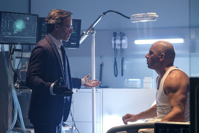 Guy Pearce (left) and Vin Diesel star in Columbia’s comic-book adaptation Bloodshot. It came in third at last weekend’s lackluster box office and made about $9.3 million.