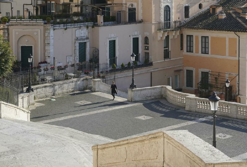 A solitary person walks the Spanish Steps in Rome on Thursday. Italian officials are warning that they might impose tougher restrictions on outdoor outings as the death toll from the coronavirus spikes.
(AP/Andrew Medichini)