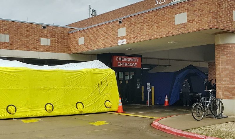 Conway Regional Health System has set up tents and has medical staff waiting Thursday in front of the hospital’s emergency room  door to screen people for coronavirus symptoms. A hospital spokesman said the health system has implemented screenings for all visitors, patients, physicians and employees.
(Arkansas Democrat-Gazette/Jeannie Roberts)
