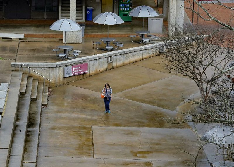 A solitary woman walks across the mostly deserted University of Arkansas at Little Rock campus in this file photo.
(Arkansas Democrat-Gazette/John Sykes Jr.)