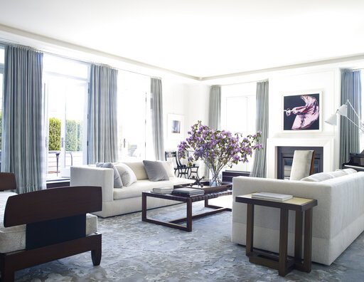 This photo shows a design project in New York by Ike Kligerman Barkley blending vintage and modern furniture. Here, the new: a blue and grey wool and silk carpet, and creamy boucle sofas. The old: "Pairs of smaller, bolder pieces - 1920s Swedish black lacquer side chairs, and 1930s mahogany slipper chairs," says designer Elizabeth Sesser, who worked on the project. The finished look is elegant and cohesive. (William Waldron/Ike Kligerman Barkley)