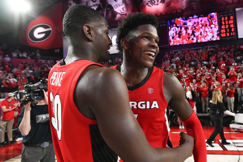 FILE - In this Feb. 19, 2020, file photo, Georgia guard Anthony Edwards, right, and forward Mike Peake celebrate after an NCAA college basketball game against Auburn in Athens, Ga. Edwards was selected to the Associated Press All-SEC first team announced Tuesday, March 10, 2020. Edwards was also named the AP SEC Newcomer of the Year. (AP Photo/John Amis, File )