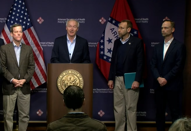 Gov. Asa Hutchinson speaks at a news conference on Sunday beside, from left: UAMS Chancellor Dr. Cam Patterson, Health Secretary Dr. Nate Smith and Arkansas Surgeon General Dr. Gregory Bledsoe.