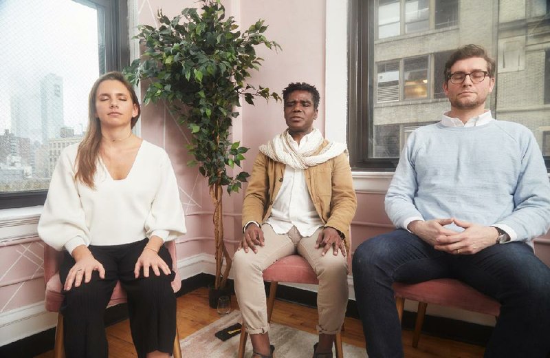 Thupten Phuntsok (center) leads a guided meditation at WayUp with Cassandra Bianco and Daniel Ryan in New York on Feb. 13. All three are part of a wellness-consulting network called Wellbeings.
(The New York Times/Andrew White)