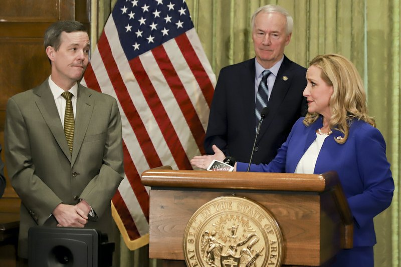 Arkansas Gov. Asa Hutchinson, center, looks on as Attorney General Leslie Rutledge speaks during a press conference to provide an update about the state's COVID-19 response Friday at the state capitol building in Little Rock. At left is Dr. Cam Patterson, chancellor of the University of Arkansas for Medical Sciences. The event was held at the Governor's conference room. - John Sykes Jr./The Arkansas Democrat-Gazette via AP