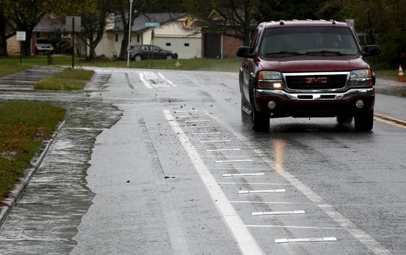 Reflector strips are visible Thursday marking the bike lanes on Rolling Hills Drive in Fayetteville. The city of Fayetteville's Transportation Division, removed bumpers and replaced them with the reflectors. Check out nwaonline.com/200322Daily/ and nwadg.com/photos for a photo gallery. (NWA Democrat-Gazette/David Gottschalk)