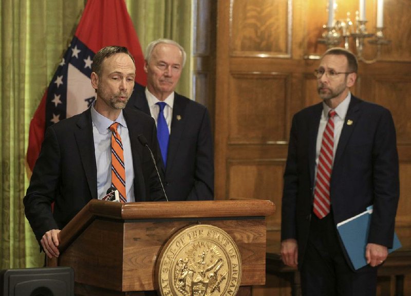  Arkansas Surgeon General Dr. Gregory Bledsoe, left, along with Gov. Asa Hutchinson, middle, and Health Secretary Dr. Nate Smith speaks Monday March 23, 2020 in Little Rock during a daily press conference about the corona virus in Arkansas. See more photos at arkansasonline.com/324governor/. (Arkansas Democrat-Gazette/Staton Breidenthal)  

