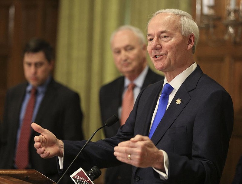  Gov. Asa Hutchinson, right, speaks along with Larry Walther, middle, Secretary of the Department of Finance and Administration and Jake Bleed, state budget director, talks Monday March 23, 2020 in Little Rock about the state's budget shortfall during a press conference
 (Arkansas Democrat-Gazette/Staton Breidenthal)  

