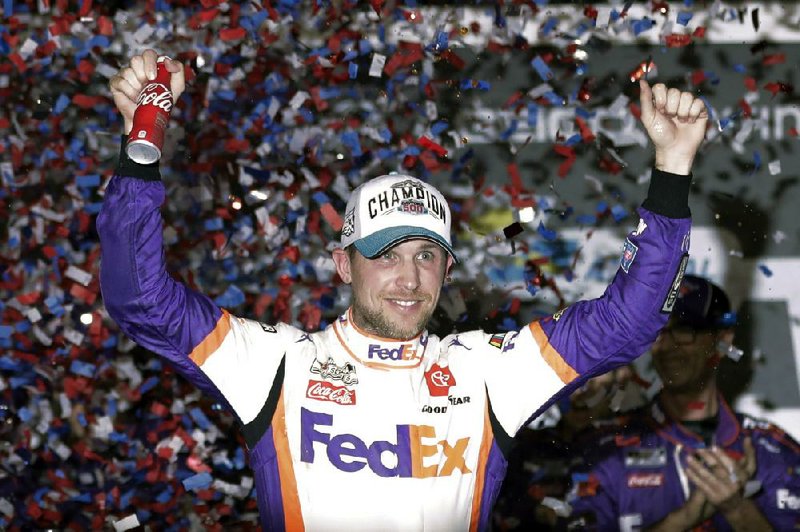 Denny Hamlin, here celebrating after winning the Daytona 500 on Feb. 17, beat Dale Earnhardt Jr. off the final corner Sunday to win a virtual Homestead-Miami Speedway race as NASCAR introduced the country to iRacing with some of the sport’s biggest stars. (AP/John Raoux) 
