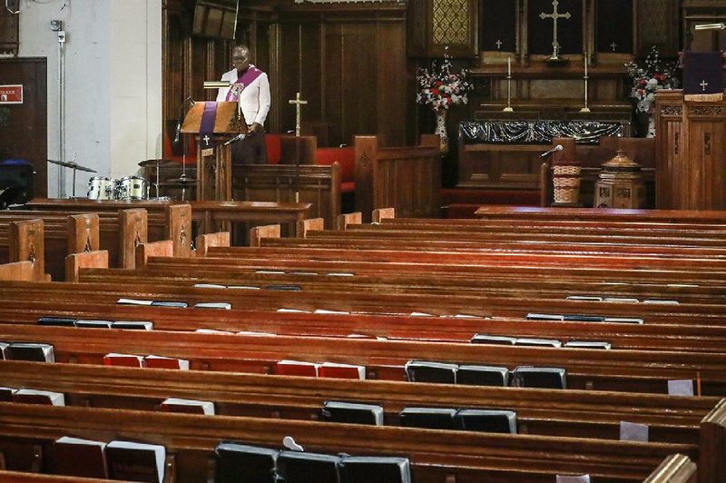 The Rev. Janet Cox of St. Paul’s Methodist Church in Brooklyn, N.Y., delivers her sermon Sunday from an empty church to home- bound congregants by a livestream broadcast as citywide restrictions aimed at controlling the covid-19 outbreak force people indoors. (AP/Bebeto Matthews) 
