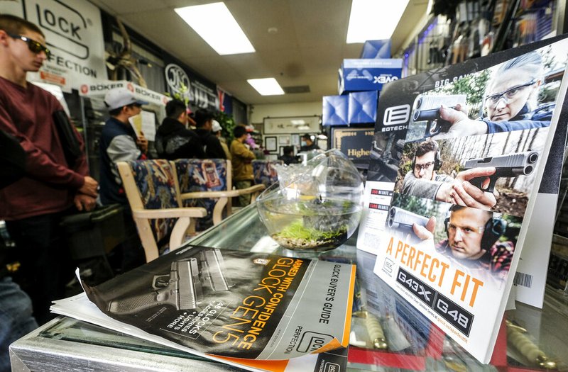 People wait in a line at a gun store in Arcadia, Calif., about 13 miles northeast of Los Angeles in Los Angeles County, in this March 15, 2020, file photo.