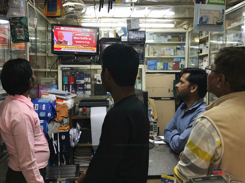 Indians watch on television Prime Minister Narendra Modi address the nation amid concerns of coronavirus outbreak in New Delhi, India, Tuesday, March 24, 2020.