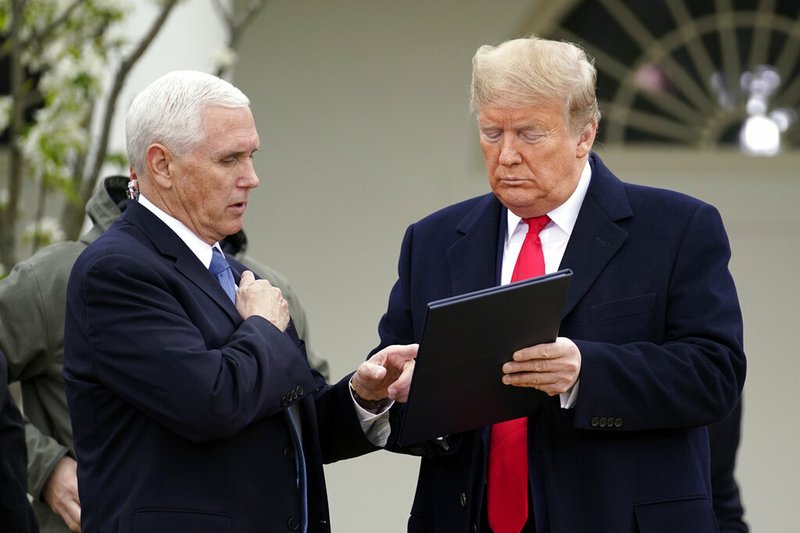 President Donald Trump speaks with Vice President Mike Pence as they arrive for a Fox News Channel virtual town hall, at the White House, Tuesday, March 24, 2020, in Washington.