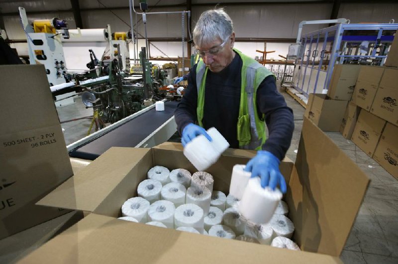 Scott Mitchell fills a box with toilet paper last week at the Tissue Plus factory in Bangor, Maine. The new company has been busy as consumers’ stockpiling has led to a shortage of toilet paper. (AP/Robert F. Bukaty) 
