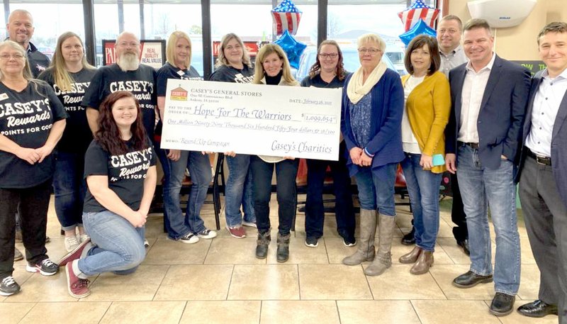 Photo Submitted
Robin Kelleher (center), president and CEO of Hope for the Warriors, accepts a $1.1 million check from Casey’s corporate leaders and local employees. The national check presentation took place in Siloam Springs because the local Casey’s raised $4,450, the highest amount of any of the more than 2,000 Casey’s stores in the country.