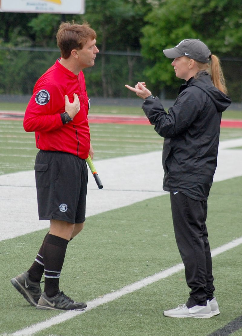 Graham Thomas/Herald-Leader Siloam Springs head girls soccer coach Abby Ray discusses a play with an official during the state soccer tournament last spring. Ray and the Lady Panthers had not gotten to play a home game this season before it was halted on March 13.