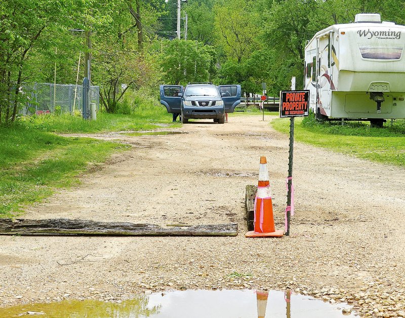 Westside Eagle Observer/RANDY MOLL FILE PHOTO Conflict rages in Springtown over this little street. The city challenged the legitimacy of previous council action in 2014 to narrow the street from 60 feet to 20 feet in an effort to open the street as an extension of Bredehoeft Road to the Don Earley Memorial Bridge on Aubrey Long Road so that traffic on a portion of Aubrey Long Road which passes a residence located on a big spring there can be reduced or stopped to protect the spring. Residents on either side of the narrowed street had marked their property lines with signs and barricades to prevent those attempting to use the street from driving across their properties.