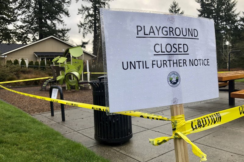 Police caution tape surrounds a playground in Lake Oswego, Ore., on Tuesday, March 24, 2020, the day after Gov. Kate Brown issued a statewide stay-at-home order that closed many businesses, as well as all playgrounds, basketball courts and sport courts. As families across the country and the globe hunker down at home, it's another danger, equally insidious if less immediately obvious, that has advocates deeply concerned: A potential spike in domestic violence, as victims spend day after day trapped at home with their abusers. (AP Photo/Gillian Flaccus) story.lead_photo.caption