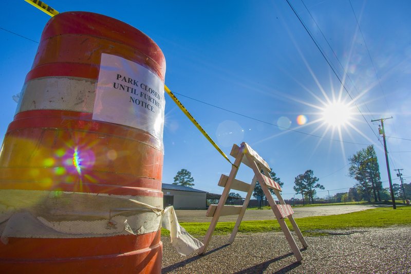 A barricade with the words "Parks closed until further notice" sits at the northern entrance to Magnolia's East Side Park on Wednesday after the city abruptly announced the closure of all city parks.  