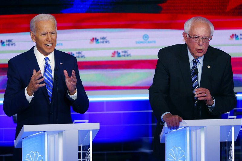 In this June 27, 2019, file photo, Democratic presidential candidates, former Vice President Joe Biden and Sen. Bernie Sanders, I-Vt., speak at the same time during the Democratic primary debate hosted by NBC News at the Adrienne Arsht Center for the Performing Arts in Miami. What might be the final showdown between the two very different Democratic candidates takes place Tuesday, March 17, 2020, during Florida's presidential primary. (AP Photo/Wilfredo Lee, File)
