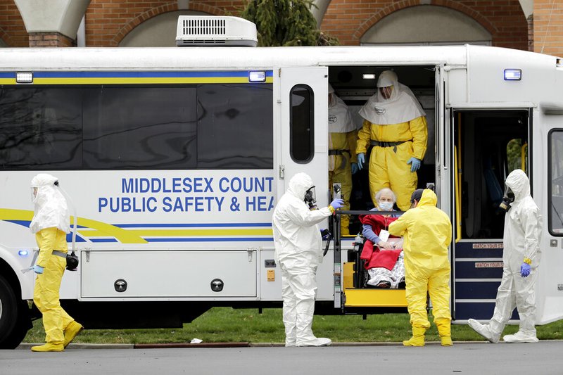 Residents from St. Joseph's Senior Home are helped onto buses in Woodbridge, N.J., Wednesday, March 25, 2020. More than 90 residents of the nursing home are being transferred to a facility in Whippany after 24 tested positive for COVID-19, according to a spokeswoman for CareOne, which operates the Whippany facility. The facility has moved its residents to other facilities to accommodate the new arrivals. (AP Photo/Seth Wenig) story.lead_photo.caption