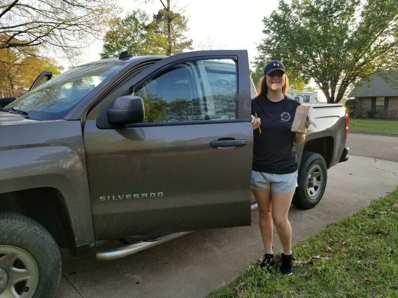 Deanna Johnson, an employee at Vine Street Liquor in Magnolia, makes the store's first home delivery on the evening of Tuesday, March 24. (submitted photo)