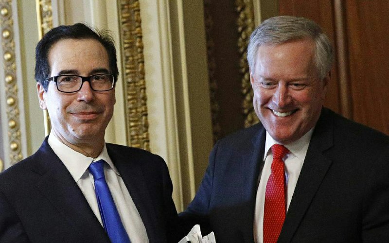 Treasury Secretary Steven Mnuchin (left) and acting White House Chief of Staff Mark Meadows step out of a meeting Tuesday on Capitol Hill as negotiations on a coronavirus relief bill continued. A deal was announced early today. More photos at arkansasonline.com/325mnuchin/.
(AP/Patrick Semansky)