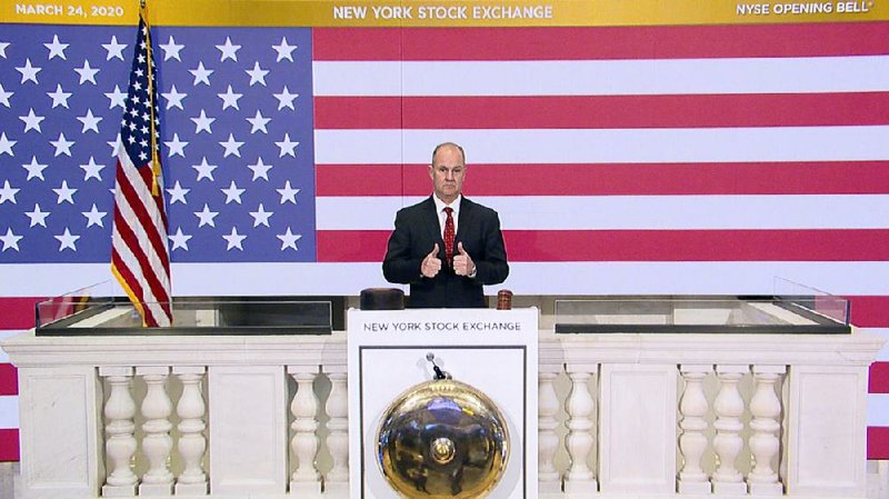Kevin Fitzgibbons, chief security officer of the New York Stock Exchange, rings the opening bell on an empty trading floor Tuesday as traders worked from home.
(AP/New York Stock Exchange)
