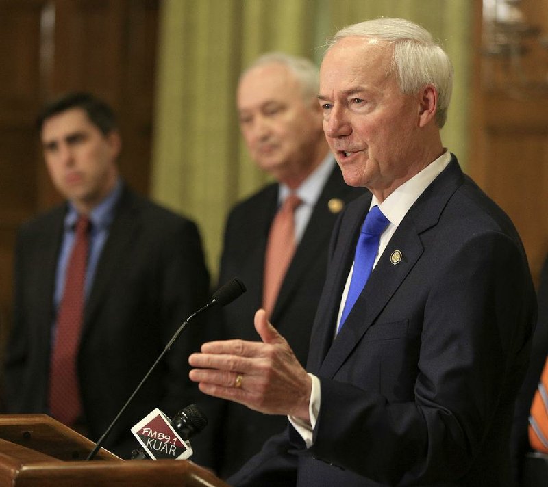  Gov. Asa Hutchinson, right, speaks along with Larry Walther, middle, Secretary of the Department of Finance and Administration and Jake Bleed, state budget director, talks Monday March 23, 2020 in Little Rock about the state's budget shortfall during a daily press conference about the corona virus in Arkansas. See more photos at arkansasonline.com/324governor/. (Arkansas Democrat-Gazette/Staton Breidenthal)  

