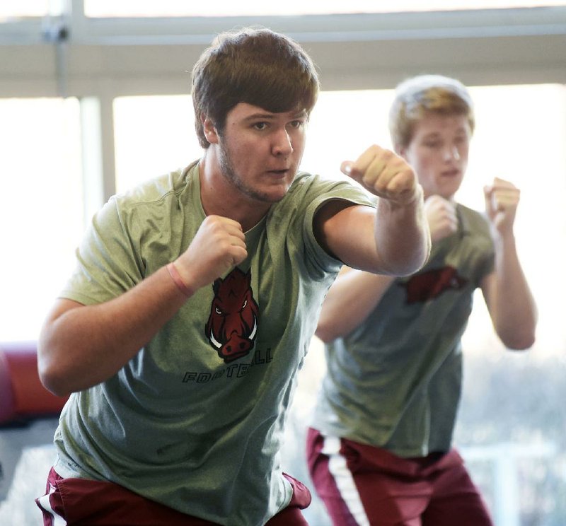 NWA Democrat-Gazette/MICHAEL WOODS @NWAMICHAELW
University of Arkansas football player Kirby Adcock, works out in the weight room Tuesday, January 31, at the Fred W. Smith Football Center in Fayetteville. 