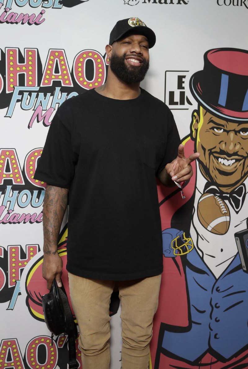 Green Bay tight end Marcedes Lewis walks on the red carpet at Shaq's Fun House, Saturday, Feb. 1, 2020, in Miami. This carnival themed music festival is one of numerous events taking place in advance of Miami hosting Super Bowl LIV on Feb. 2. (AP Photo/Lynne Sladky)