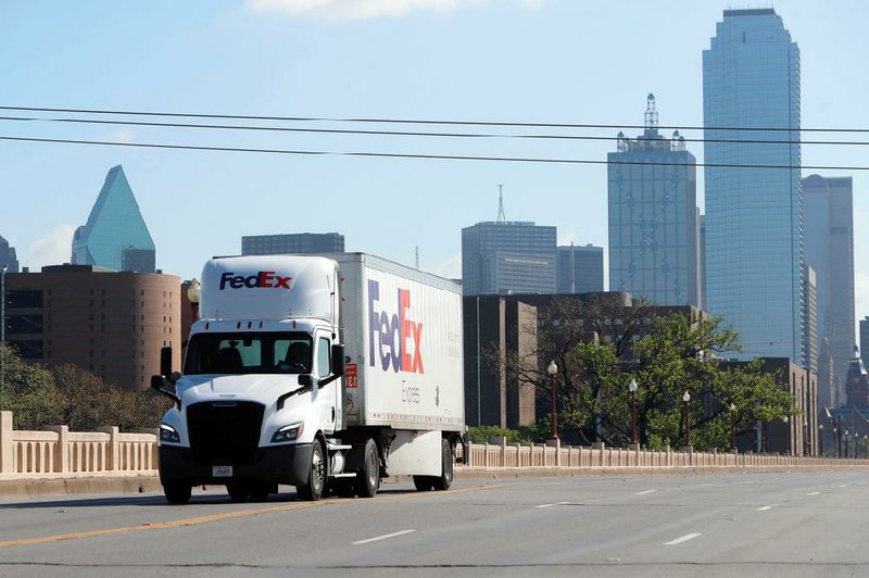 A FedEx truck is the only vehicle on the road near downtown Dallas on Tuesday with Dallas County under a shelter-in-place order. U.S. trucking companies are riding a surge in cargo demand from online orders. (AP/LM Otero) 