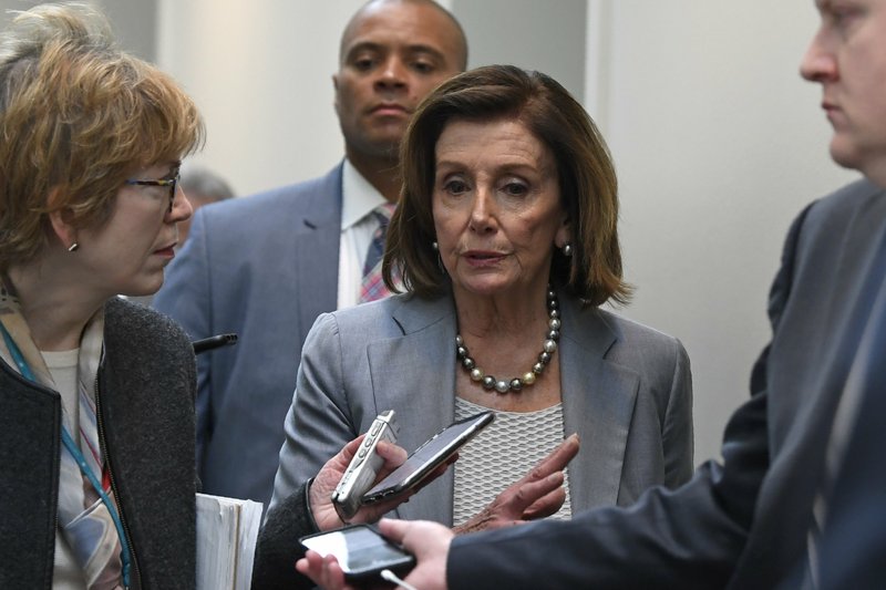 House Speaker Nancy Pelosi of Calif., is followed by reporters and staff as she walks back to her office following a meeting with House Democrats on Capitol Hill in Washington, Wednesday, March 11, 2020. (AP Photo/Susan Walsh)