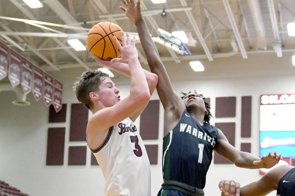 Siloam Springs sophomore Josh Stewart, left, goes to the basket as Little Rock Christian's Layden Blocker, right, defends on the play.