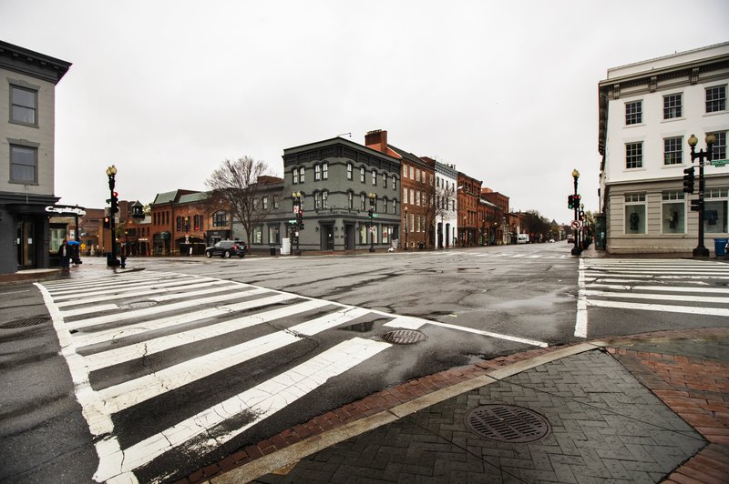 The streets in the shopping district of Georgetown are nearly empty Wednesday, March 25, 2020, in Washington. Streets are almost empty in usually crowded and busy shopping areas of the capital as Washington residents are urged to stay home to contain the spread of the coronavirus. (AP Photo/Manuel Balce Ceneta)