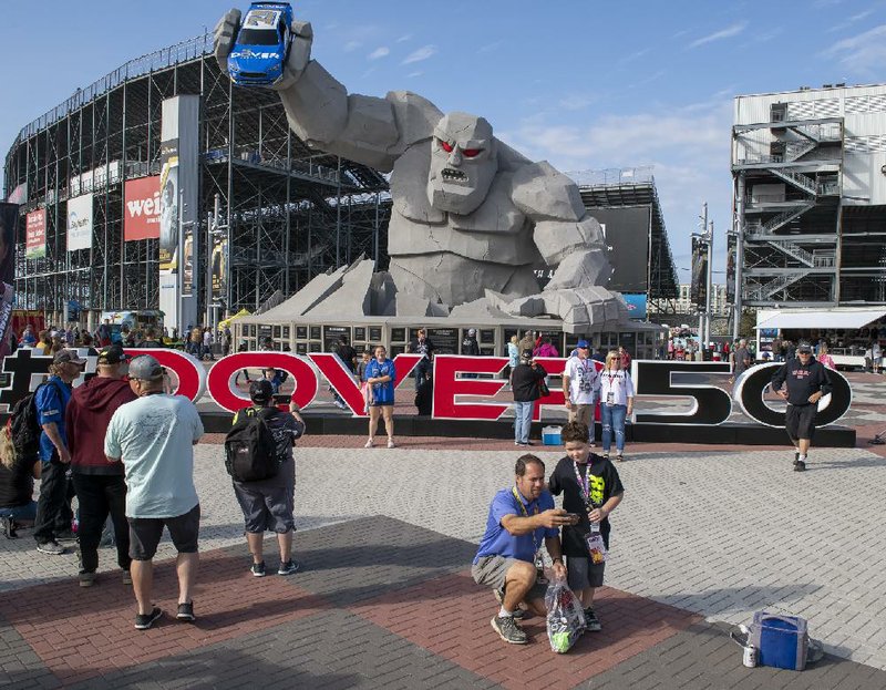 NASCAR fans take photos in front of Miles the Monster before the NASCAR Cup Series race in October. With seven races postponed because of coronavirus concerns, NASCAR is still trying to juggle its schedule. Dover International Speedway potentially could have its Cup Series race on the same day as the Indianapolis 500 in August.
(AP/Jason Minto)