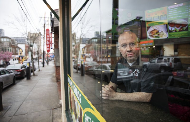 Paul Boutros, owner of East Side Pockets, a small restaurant near Brown University, looks out onto an empty street since students were sent home two weeks ago, Wednesday, March 25, 2020, in Providence, R.I. &quot;He's not being realistic. How can you open if the cases are climbing day after day?&quot; asked Boutros on Trump's call to restart the economy by mid-April. &quot;You go to Walmart, you don't know if the people around you, if they have the virus. People come to our restaurant. I don't know if they have the virus.&quot; (AP Photo/David Goldman)
