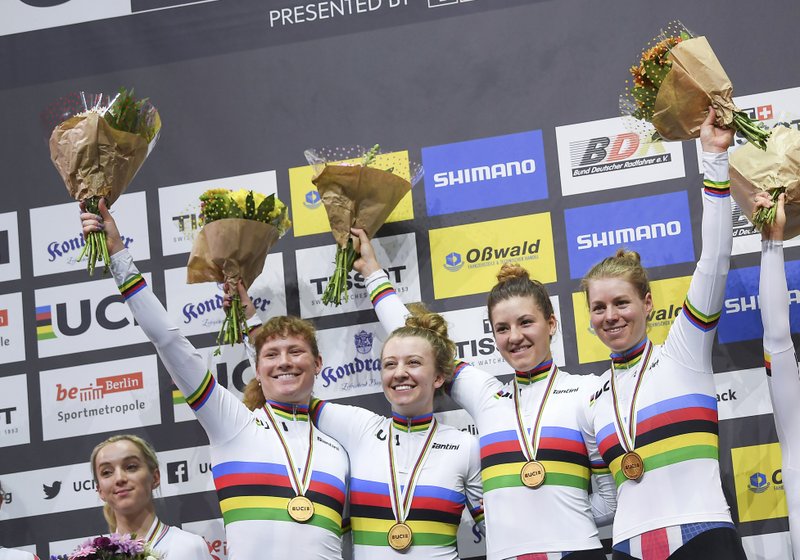 The USA team, Lily Williams, from left, Emma White, Chloe Dygert, and Jennifer Valente celebrate winning the gold medal at the Feb. 27 awards ceremony for the World Championship final of the Women Team Pursuit event in Berlin, Germany. - Photo by Sebastian Gollnow/dpa via The Associated Press 