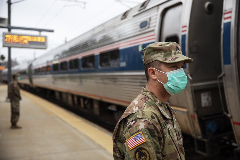 Rhode Island National Guardsmen look for passengers getting off from New York as a train arrives Saturday in Westerly, R.I. More photos at arkansasonline.com/329targeting/.
(AP/David Goldman)