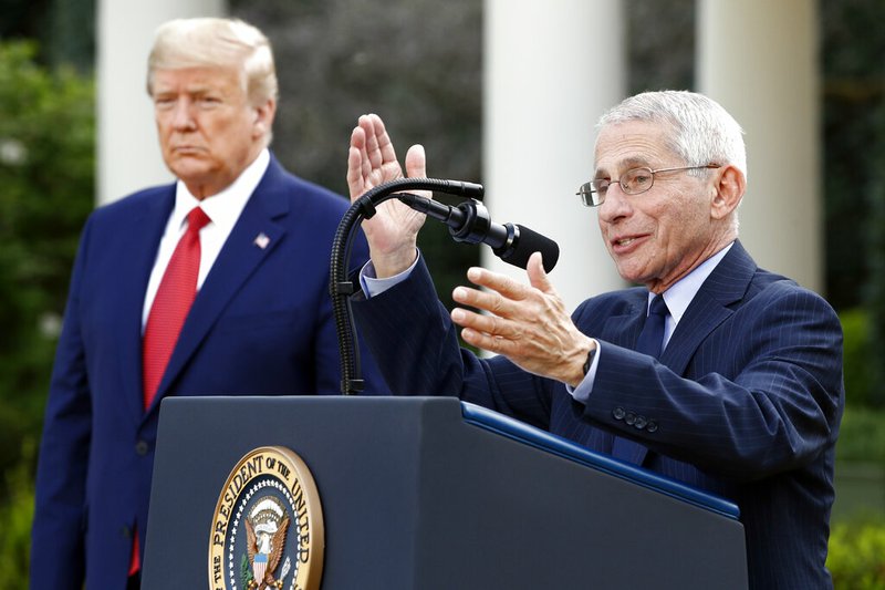 Dr. Anthony Fauci, director of the National Institute of Allergy and Infectious Diseases, speaks during a coronavirus task force briefing in the Rose Garden of the White House on Sunday, March 29, 2020, in Washington as President Donald Trump listens.
