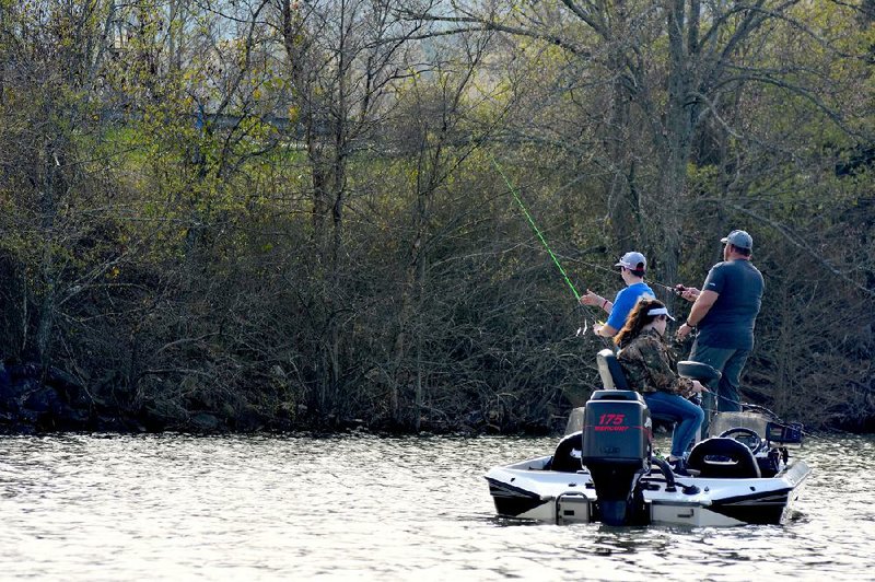 A family fishes for white bass Thursday at Lake Maumelle.
(Arkansas Democrat-Gazette/Bryan Hendricks)