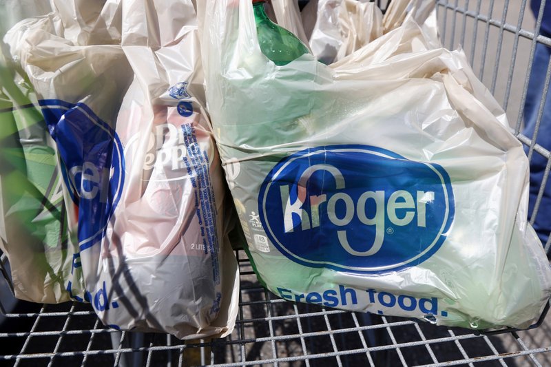 FILE - In this June 15, 2017, file photo, bagged purchases from the Kroger grocery store in Flowood, Miss., sit inside this shopping cart. A group of Instacart workers are organizing a strike across the U.S. starting Monday, March 30, 2020, to demand more pay and protection as they struggle to meet a surge in demand for grocery deliveries during the coronavirus pandemic. It was unclear how many of Instacart's shoppers - most of whom work as independent contractors - would join the strike. (AP Photo/Rogelio V. Solis, File)

