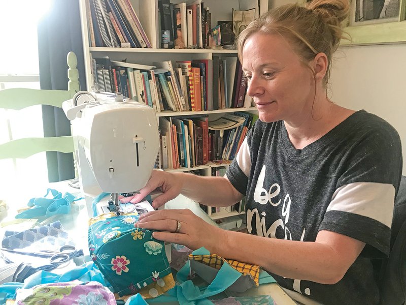 Jenny Wallace of Greenbrier makes a mask out of fabric scraps. She started the Let’s Sew Face Masks page after seeing the pleas for masks from health care workers. More than 4,000 requests from Arkansas and other states have poured in to the group, and Wallace said more seamstresses are needed, as well as elastic.