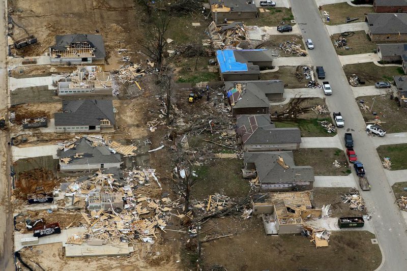 Residents and volunteers continue cleanup on Monday, March 30, 2020, of a residential area hit by Saturday's EF-3 tornado in Jonesboro. 
(Arkansas Democrat-Gazette/Thomas Metthe)