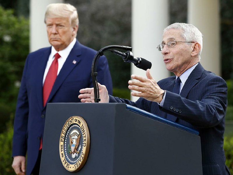 Dr. Anthony Fauci, director of the National Institute of Allergy and Infectious Diseases, speaks next to President Donald Trump on Sunday during a coronavirus task force briefing in the Rose Garden of the White House. (AP/Patrick Semansky) 
